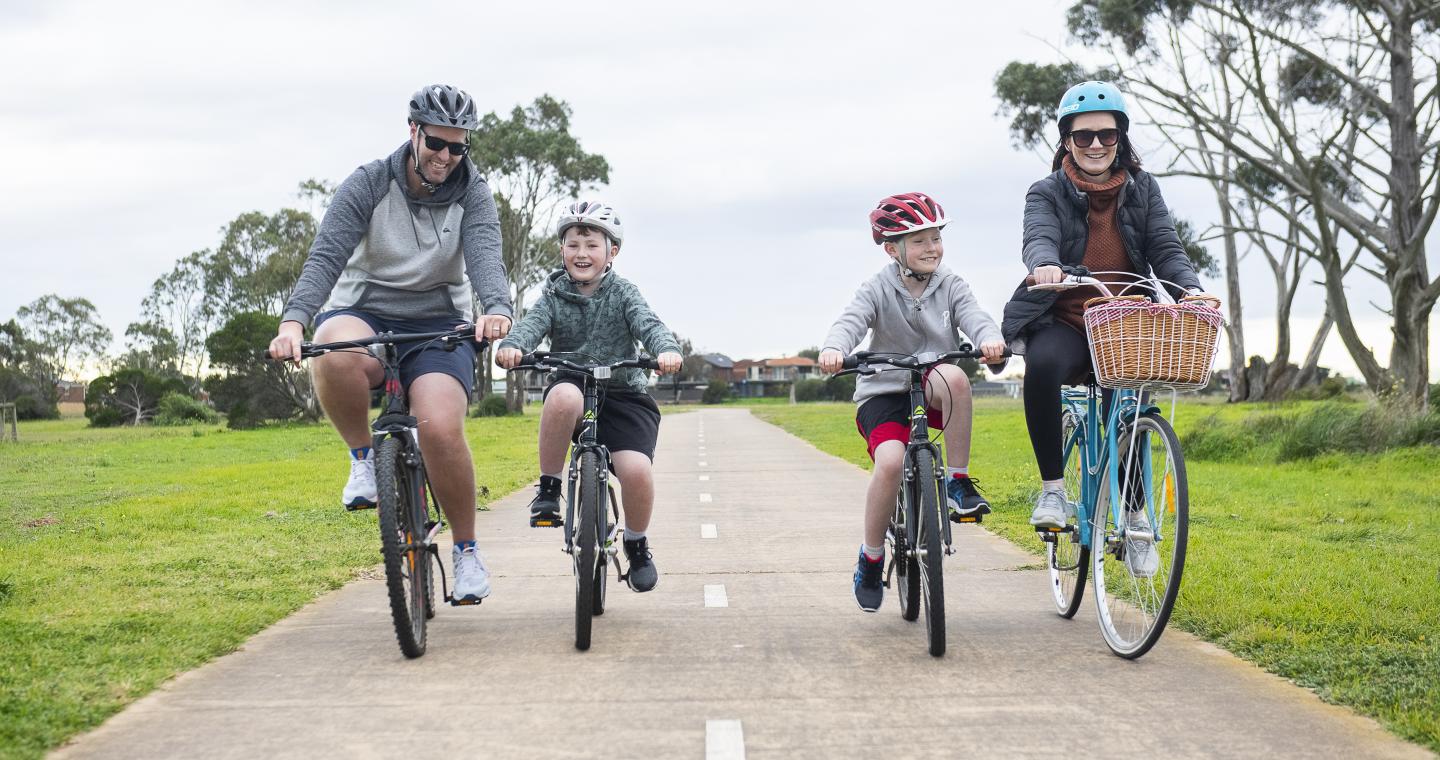 Family riding on bike path