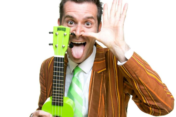 Man holding a lime green ukelele