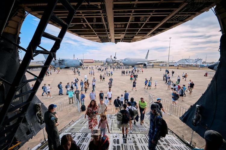 Attendees Walking Inside a Military Plane