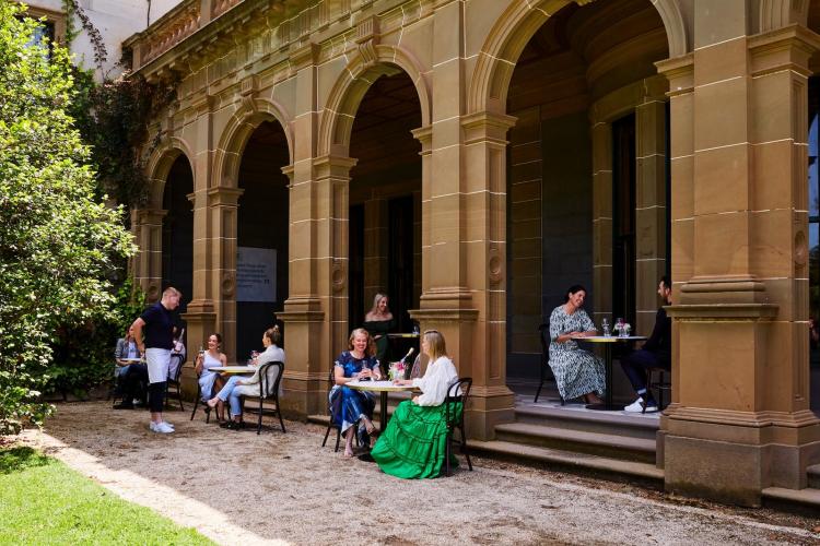 People enjoying al-a-cart menu dining under the eaves of The Refectory at Werribee Mansion