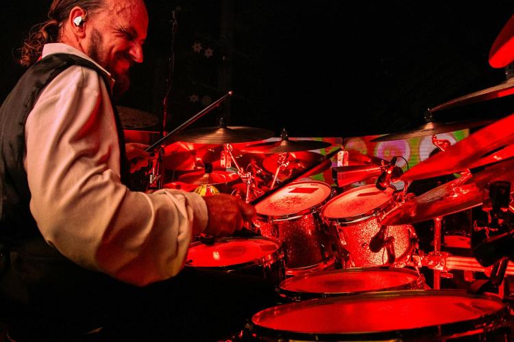 Former Dreams Show members performing Fleetwood Mac hits onstage with full crowd energy.