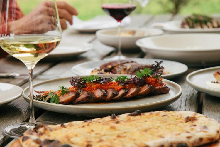 food and a glass of wine on a table