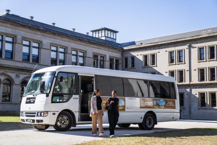 two women walking in front of a shuttle bus at Lancemore Mansion Hotel